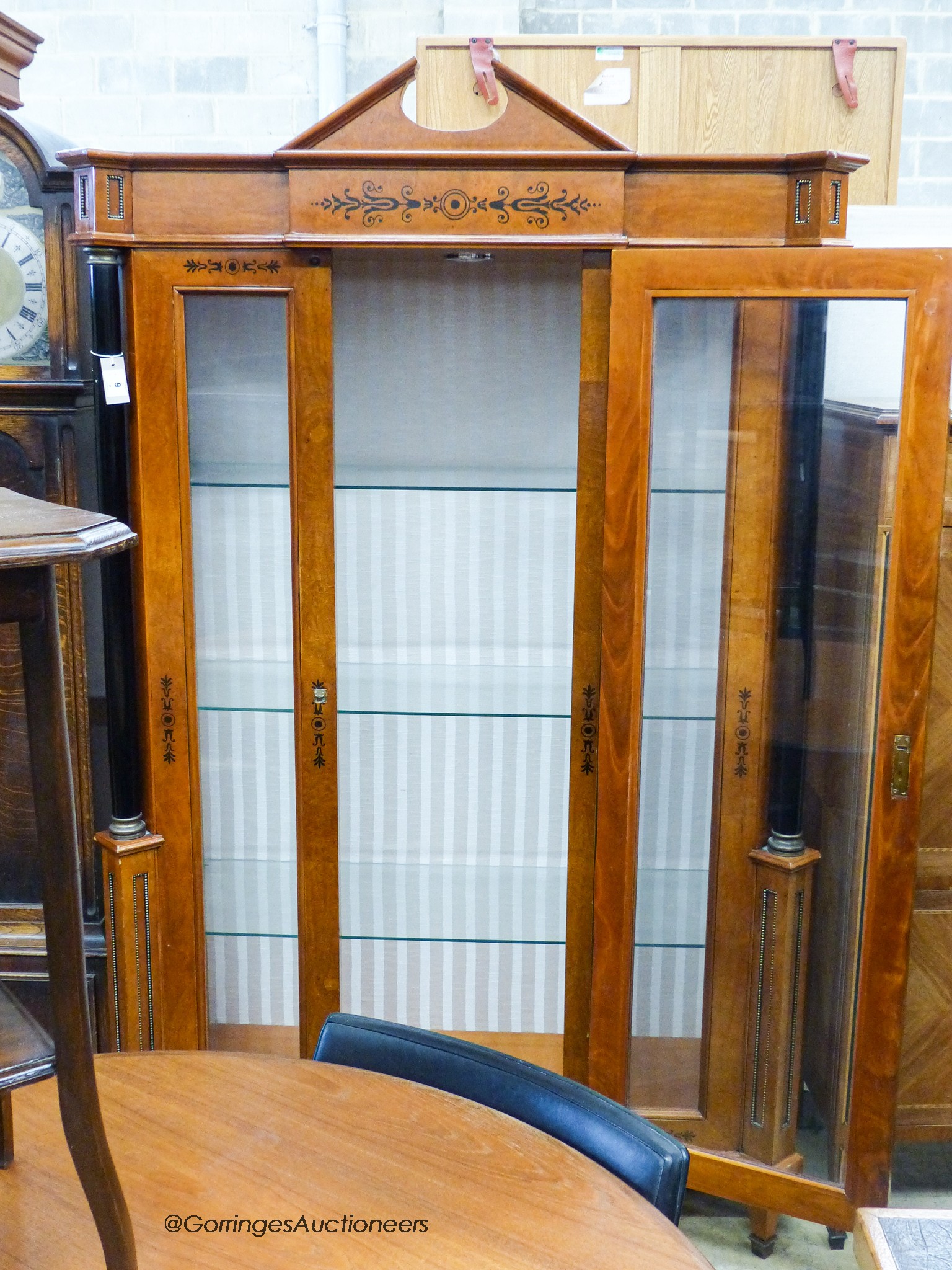 A Biedermeier style ebony inlaid mahogany breakfront display cabinet, W.120cm D.47cm H.197cm